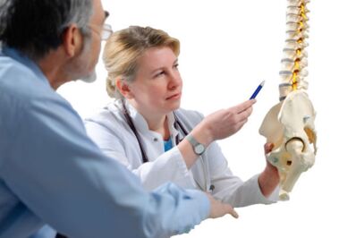 Der Arzt berät den Patienten zu den Anzeichen einer Osteochondrose der Brustwirbelsäule